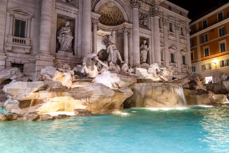 Illuminated Trevi Fountain (Fontana di Trevi) at night, famous fountain in the Trevi district of Rome - Italy