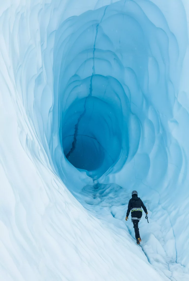 Walking toward an ice cave with deep blue ice on the Matanuska Glacier in Alaska