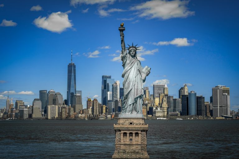 The Statue of Liberty over the Scene of New york cityscape river