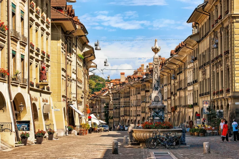 People at Kreuzgassbrunnen in Kramgasse street in Bern