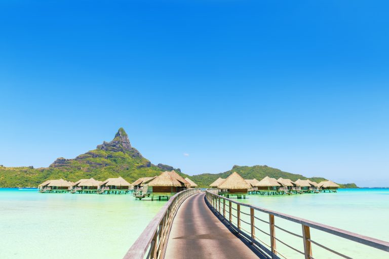 Overwater pass to villas on a tropical lagoon of Bora Bora Islan