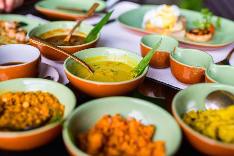 Variety of Sri Lankan curry in bowls on table