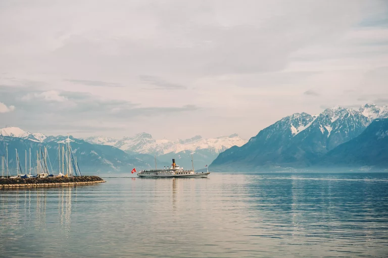 Steam boat with French and Swiss flags floating on Lake Geneva, Switzerland