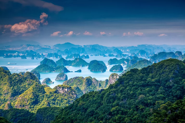 scenic view over Ha Long bay from Cat Ba island, Ha Long city in the background, UNESCO world heritage site, Vietnam