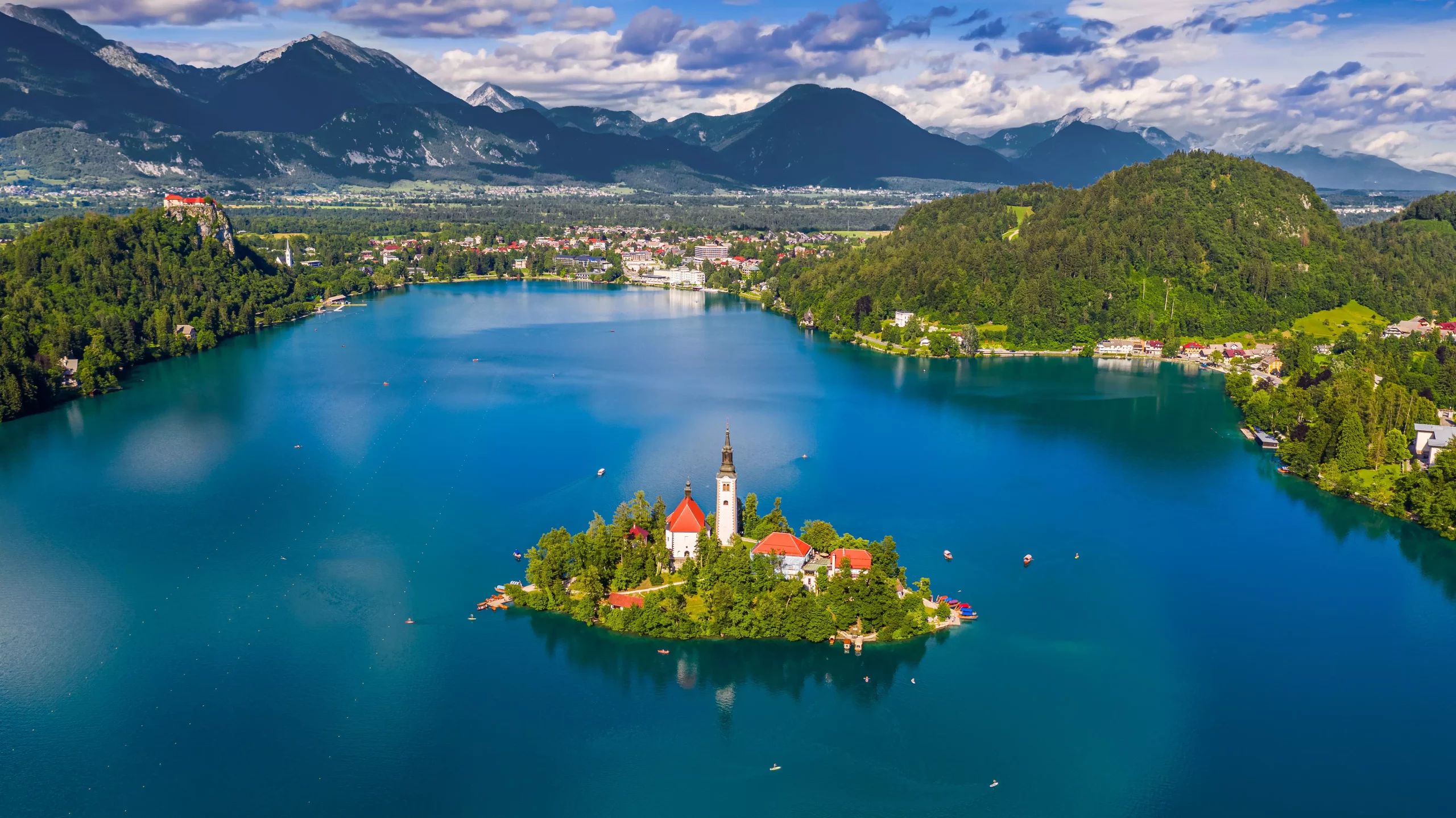 Licensed   FILE #:  283060241  Preview Crop  Find Similar DIMENSIONS 5320 x 2986px FILE TYPE JPEG CATEGORY Landscapes LICENSE TYPE Standard Bled, Slovenia - Aerial panoramic skyline view of Lake Bled (Blejsko Jezero) with the Pilgrimage Church of the Assumption of Maria, Julian Alps and Bled Castle at background on a sunny summer day