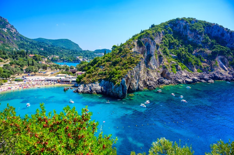 Agios Spiridon Beach with crystal clear azure water and white beach in beautiful landscape scenery - paradise coastline of Corfu island at Paleokastritsa, Ionian archipelago, Greece