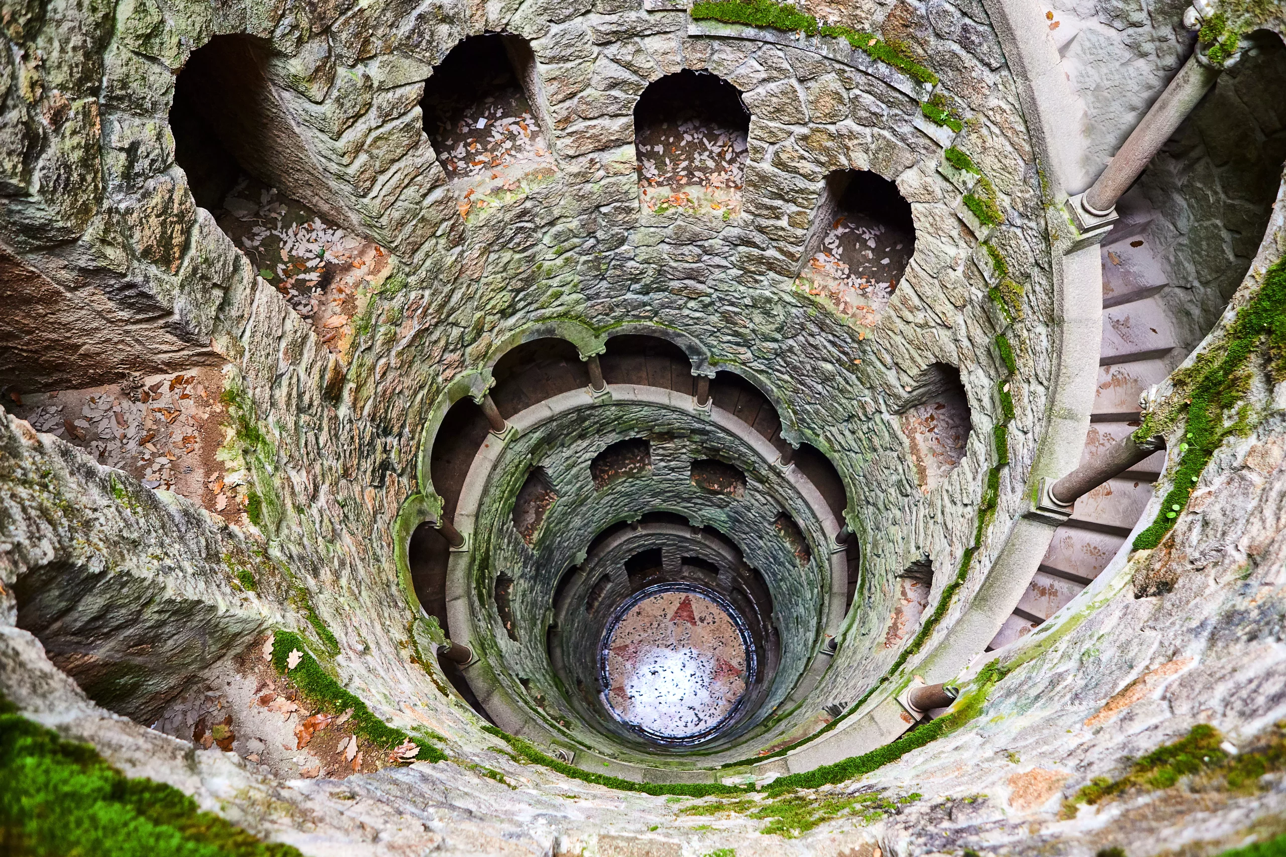 The Initiation well of Quinta da Regaleira It's a 27 meter staircase that leads straight down underground and connects with other tunnels via underground. located in Sintra, Portugal