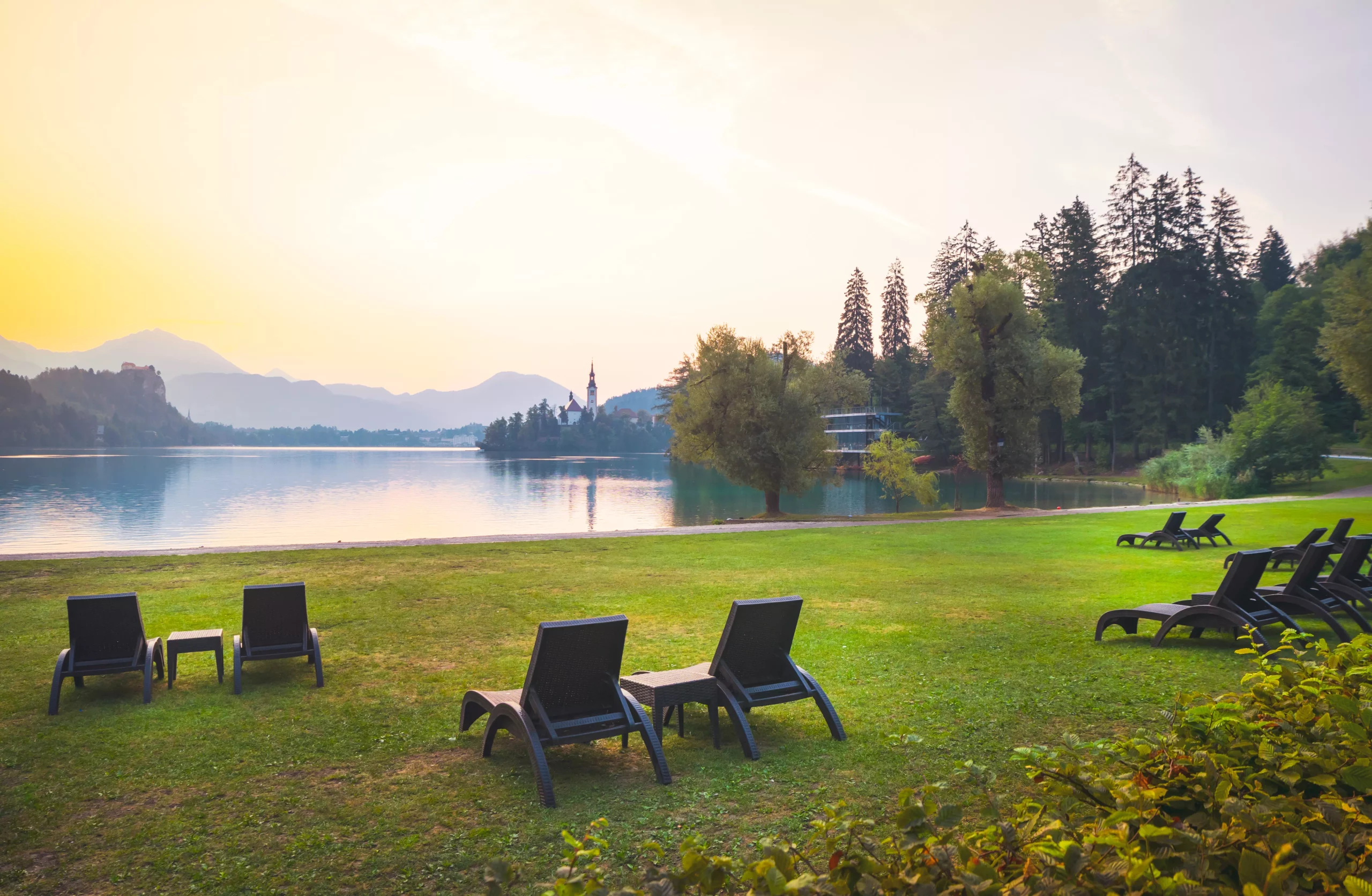 Many armchairs on the grass with no people by the bled lake in Slovenia during the morning Nature retriet in central europe and Slovenia