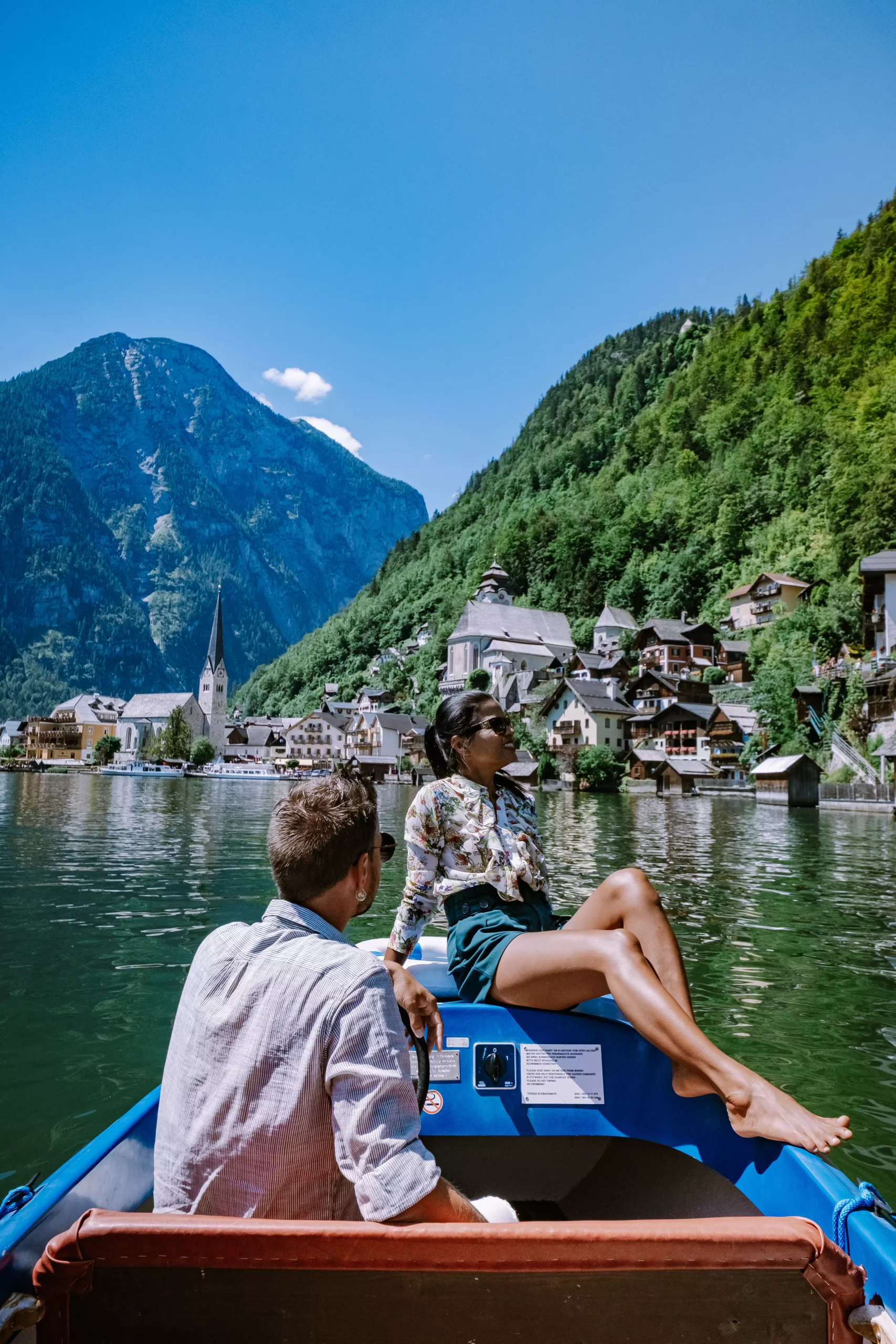 couple visit during summer vacation Hallstatt village on Hallstatter lake in Austrian Alps Austria Europe