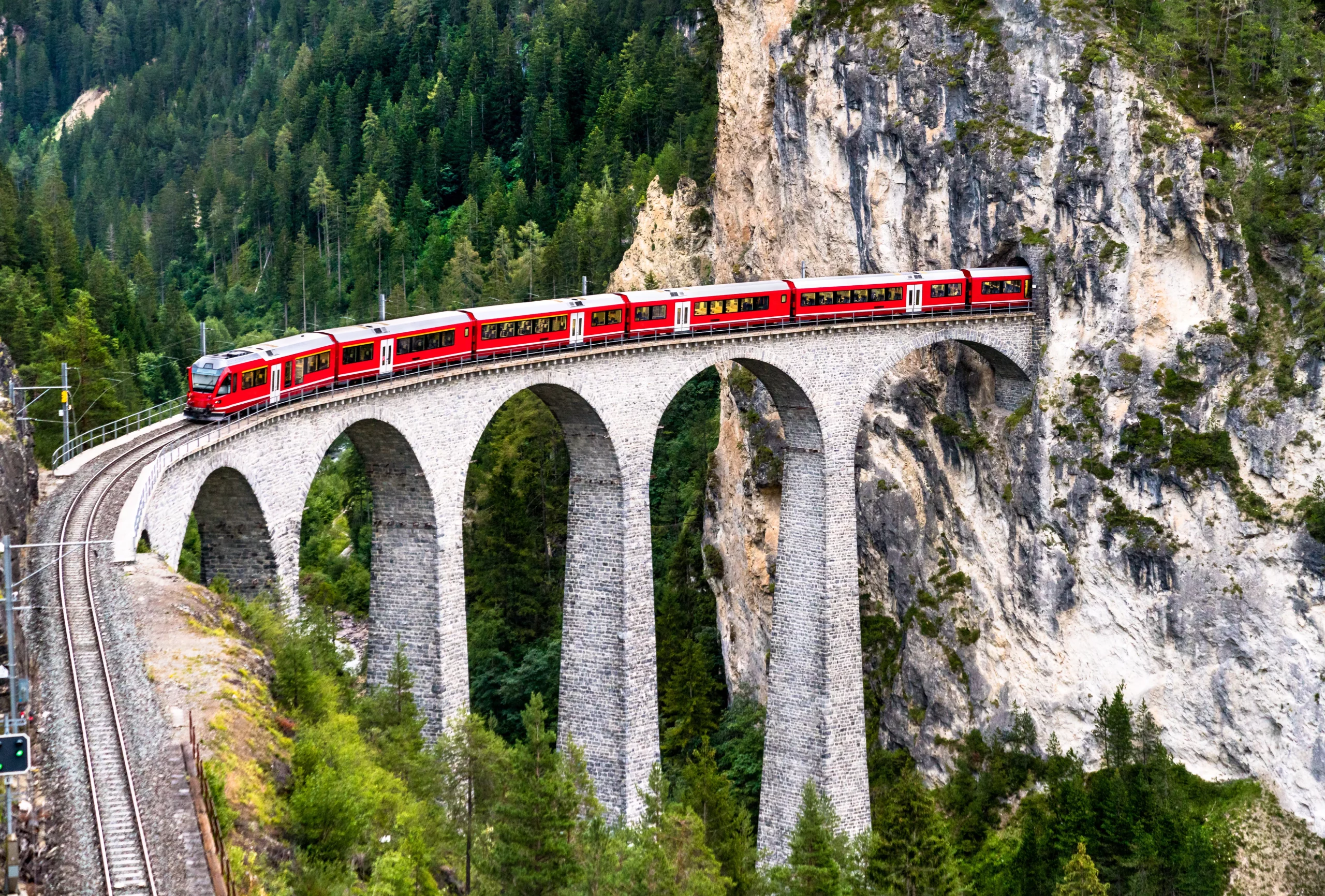 Passenger train crossing the Landwasser Viaduct in Switzerland