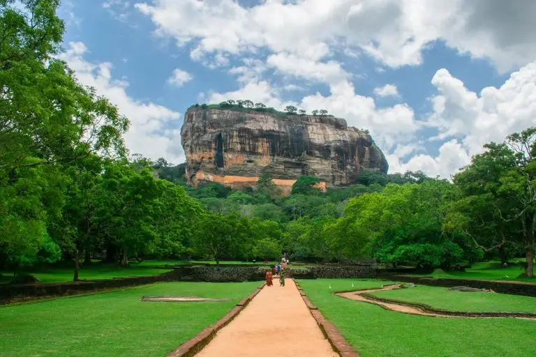 Sigiriya Rock Fortress towering over lush green landscape, a famous UNESCO World Heritage site in Sri Lanka.